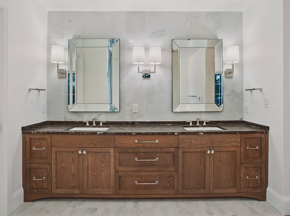 Custom wood cabinetry and silver hardware for a two sink bathroom vanity