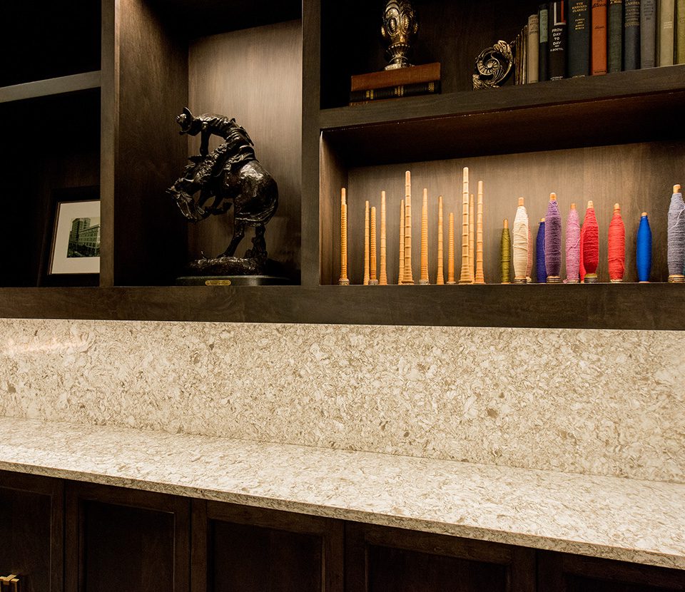 Marble counter top with mahogany shelving and custom cabinetry