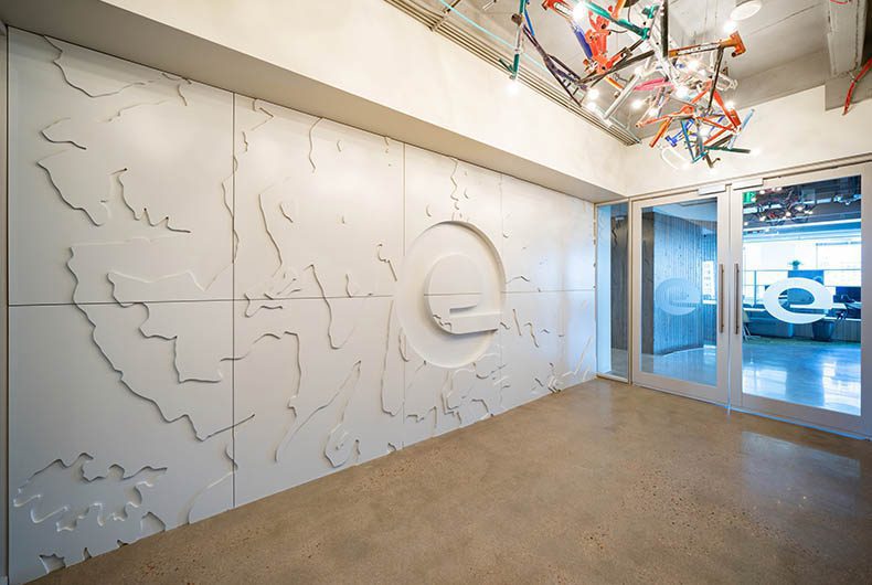 Expedia branded wall art installation in office entryway