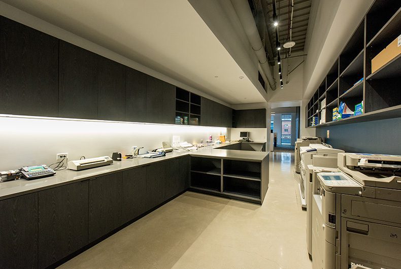 Copy room with built-in wood shelving and cabinetry