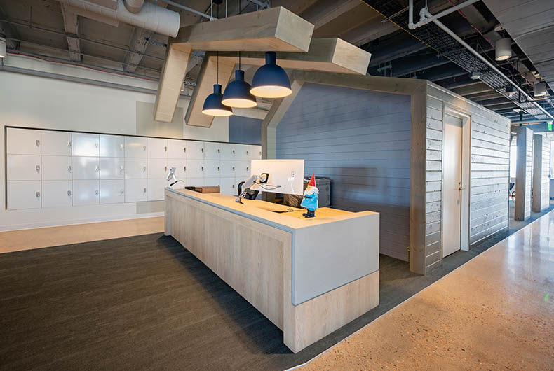 Office mail room with custom wood desk and installed hanging wood ceiling panels