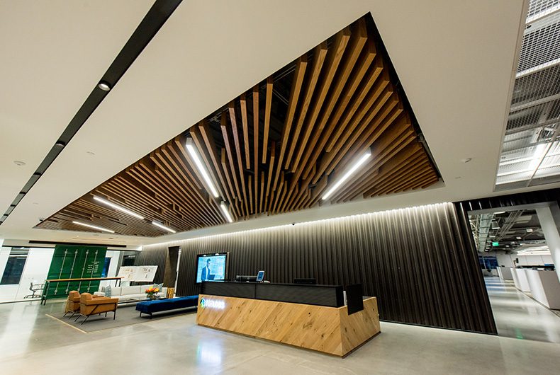 Office lobby with intricate wood art ceiling panels