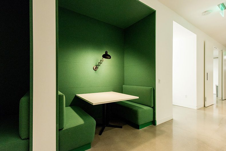 Office cubby spaces with built-in tables and booth seating