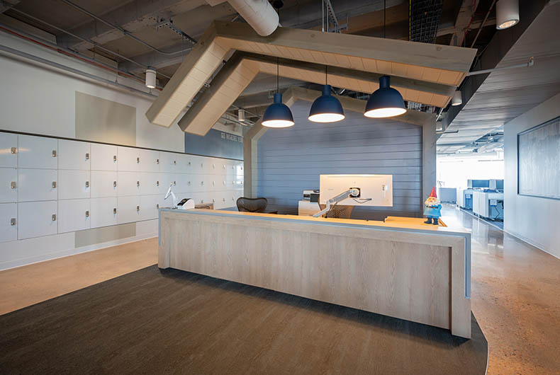 Expedia office lobby with wooden desk and installed decorative wood ceiling panels