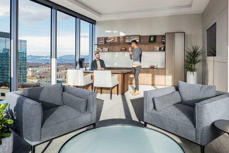 Personal office with desk, built-in shelving and sitting area