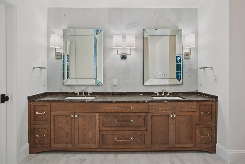 Custom wood cabinetry and silver hardware for a two sink bathroom vanity