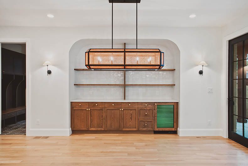 High-end designed living room with wet bar and built-in shelving